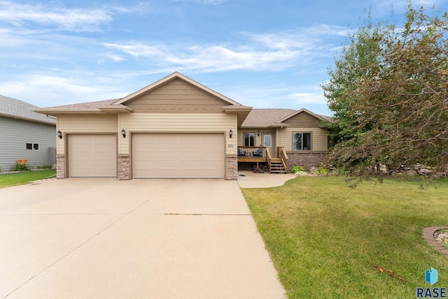 single story home with a garage, stone siding, concrete driveway, and a front lawn