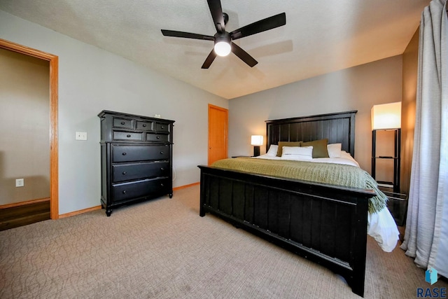 bedroom featuring baseboards, light colored carpet, and ceiling fan