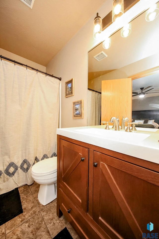 bathroom featuring visible vents, toilet, and vanity