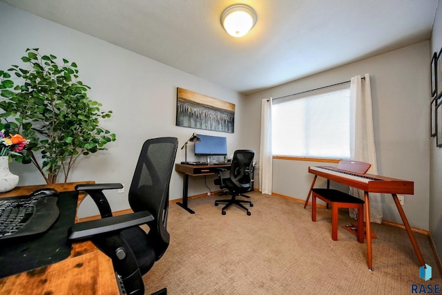 office area featuring light colored carpet and baseboards