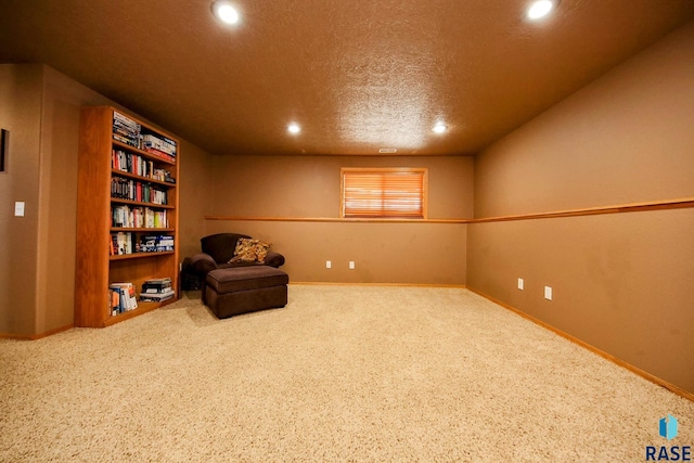 living area featuring carpet flooring, recessed lighting, baseboards, and a textured ceiling