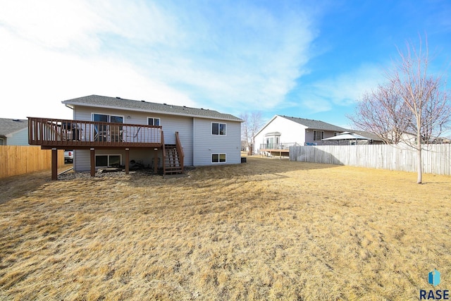 rear view of house with stairway, a deck, and a fenced backyard