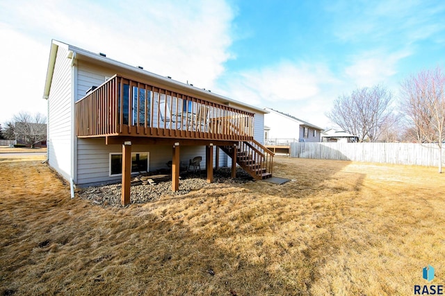 rear view of house with stairway, a deck, and fence