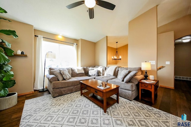 living room featuring visible vents, wood-type flooring, baseboards, and ceiling fan with notable chandelier