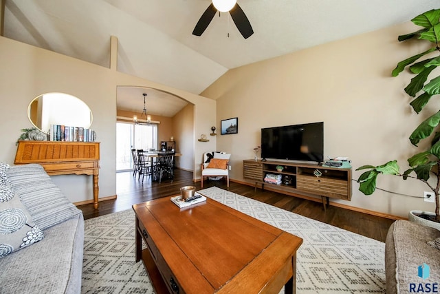 living room with ceiling fan with notable chandelier, vaulted ceiling, wood finished floors, and arched walkways