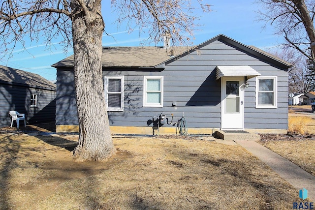 view of front of home with a shingled roof