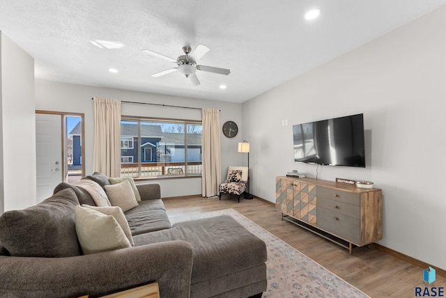 living area featuring ceiling fan, recessed lighting, light wood-type flooring, and baseboards