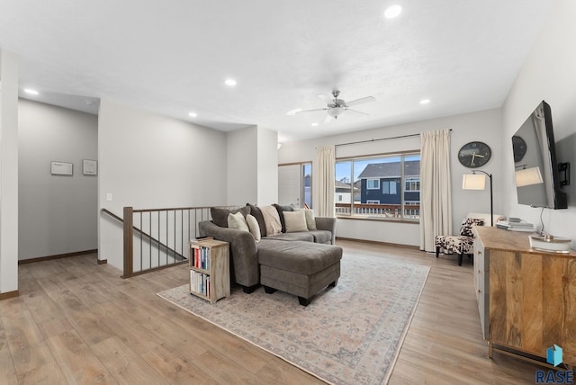 living room with baseboards, recessed lighting, a ceiling fan, and light wood-style floors