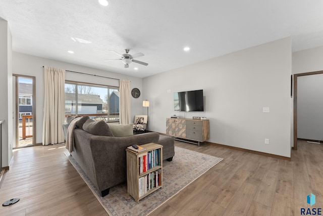 living area featuring a ceiling fan, recessed lighting, light wood-type flooring, and baseboards