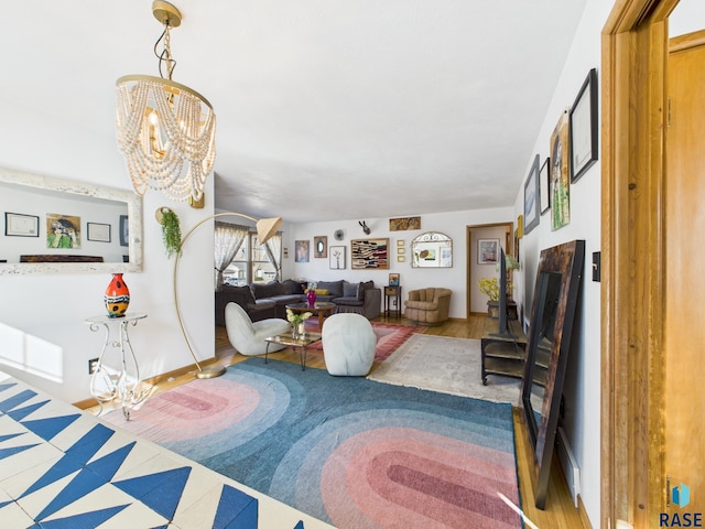 living area with a notable chandelier and wood finished floors