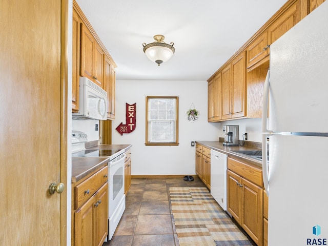 kitchen featuring brown cabinetry, white appliances, stainless steel countertops, and baseboards