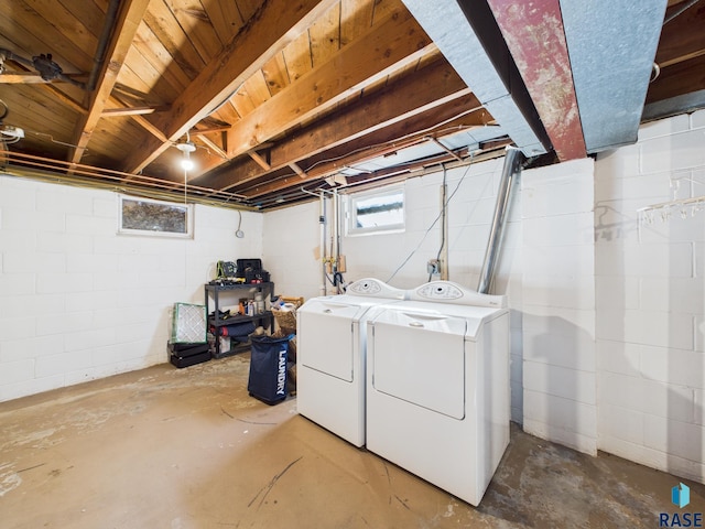 clothes washing area with separate washer and dryer and laundry area