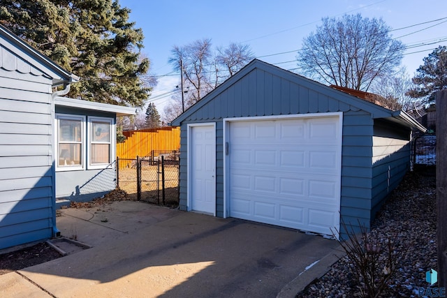 detached garage featuring fence