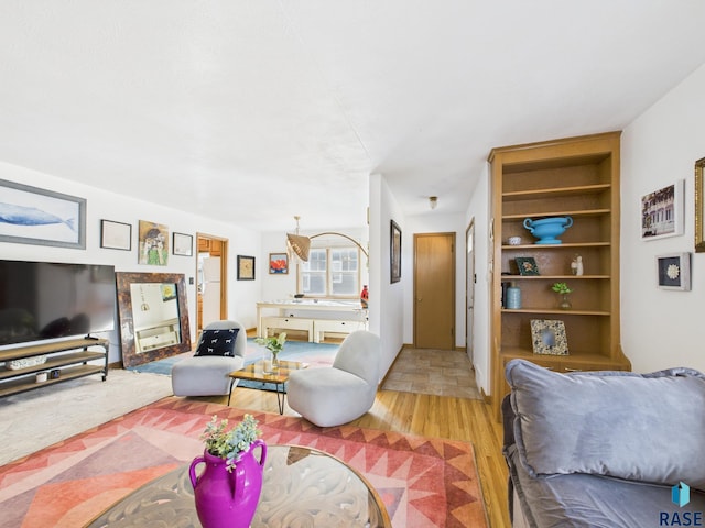 living area featuring built in features and light wood-type flooring