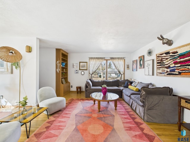 living area with wood finished floors and a textured ceiling