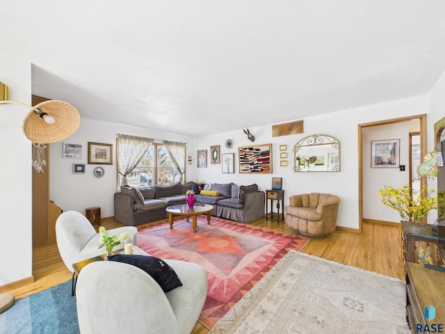 living room featuring baseboards and wood finished floors