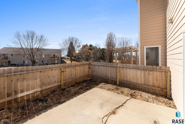 view of patio featuring a residential view and a fenced backyard