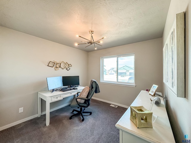 office space with a textured ceiling, baseboards, an inviting chandelier, and dark colored carpet