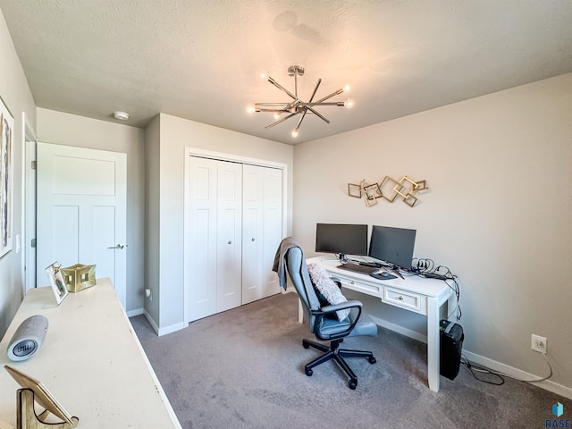 office space featuring a textured ceiling, baseboards, carpet floors, and a chandelier