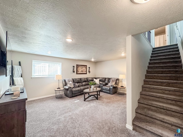 carpeted living room featuring recessed lighting, a textured ceiling, stairs, and baseboards