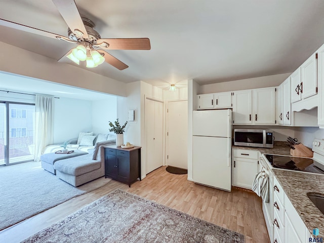 kitchen featuring open floor plan, light wood-style floors, white cabinets, white appliances, and a ceiling fan