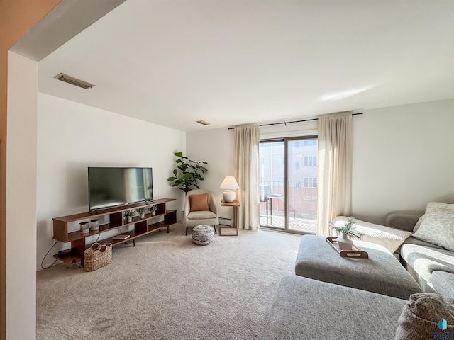 living room featuring visible vents and carpet