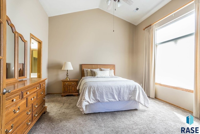 carpeted bedroom featuring visible vents, baseboards, and lofted ceiling