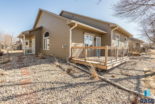 view of side of home with a wooden deck