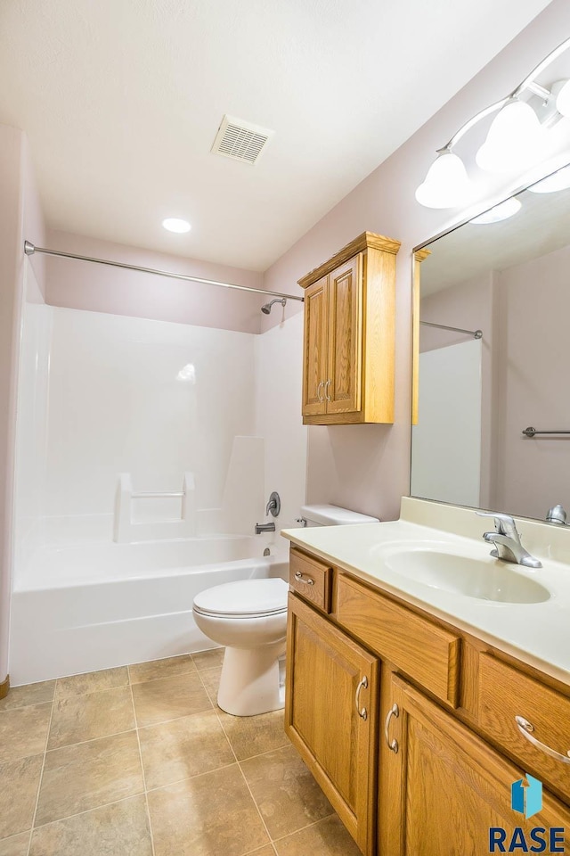 bathroom with tile patterned floors, visible vents, toilet, washtub / shower combination, and vanity