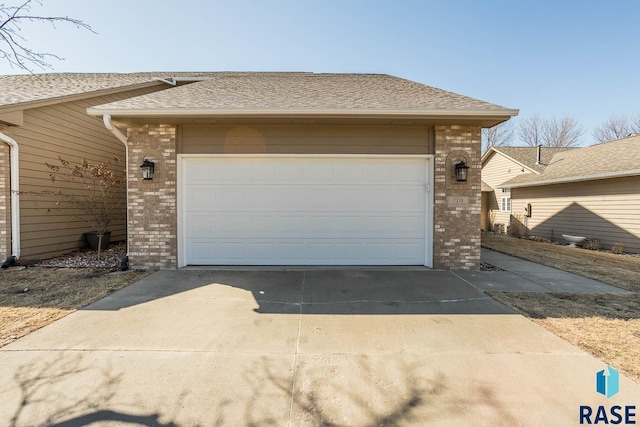 garage featuring concrete driveway