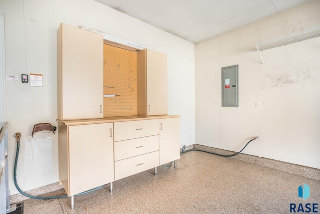 interior space with electric panel and speckled floor