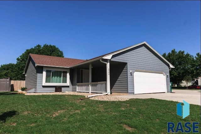 ranch-style home featuring a front yard, concrete driveway, and a garage