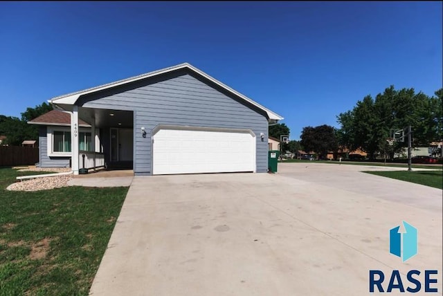 view of front facade featuring a front yard, concrete driveway, and an attached garage