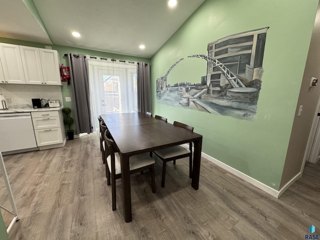 dining room featuring recessed lighting, baseboards, light wood-style floors, and lofted ceiling