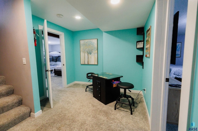 carpeted home office with baseboards