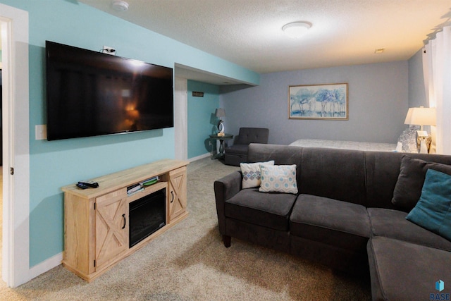 living room featuring light colored carpet, baseboards, and a textured ceiling