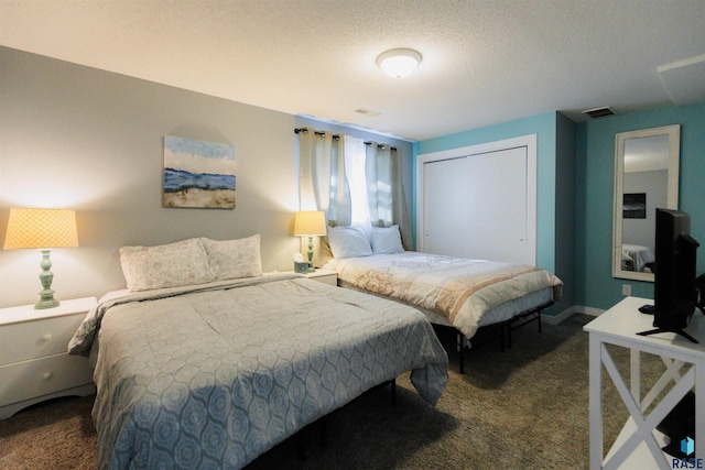 bedroom featuring baseboards, visible vents, a closet, a textured ceiling, and dark colored carpet