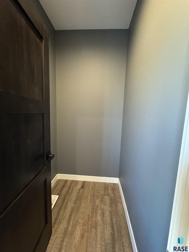 interior space featuring wood finished floors and baseboards