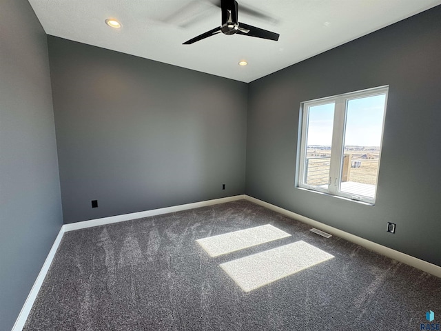 carpeted empty room featuring recessed lighting, visible vents, baseboards, and a ceiling fan