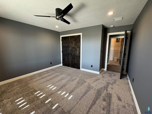 unfurnished bedroom with baseboards, visible vents, a closet, a textured ceiling, and carpet flooring