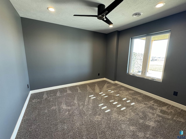 empty room with baseboards, carpet, a ceiling fan, and a textured ceiling