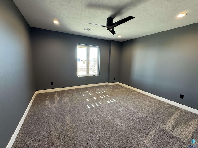 spare room with visible vents, a ceiling fan, a textured ceiling, carpet floors, and baseboards