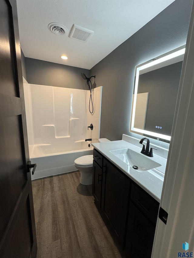 bathroom with visible vents, toilet, wood finished floors, and vanity