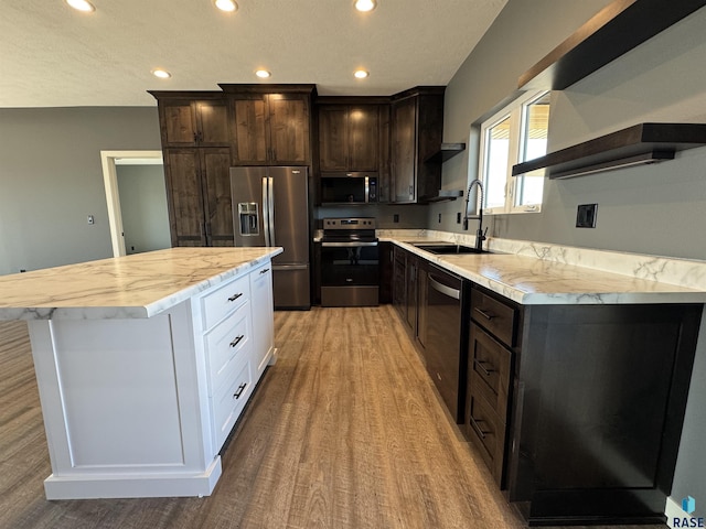 kitchen featuring open shelves, a sink, stainless steel appliances, dark brown cabinets, and a center island