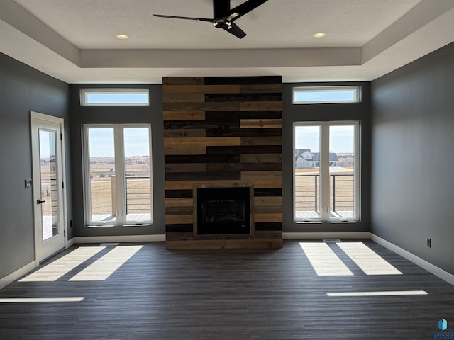 unfurnished living room with wood finished floors, a ceiling fan, baseboards, recessed lighting, and a large fireplace