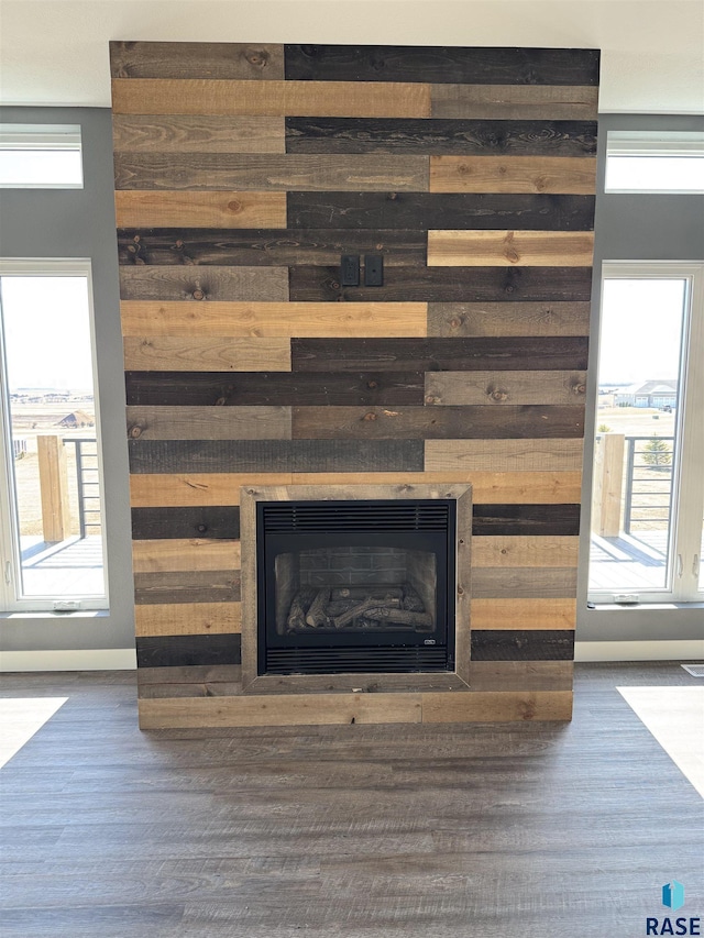 interior details featuring a fireplace and wood finished floors