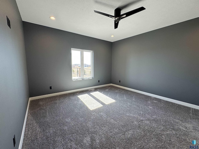 carpeted spare room featuring recessed lighting, visible vents, baseboards, and a ceiling fan