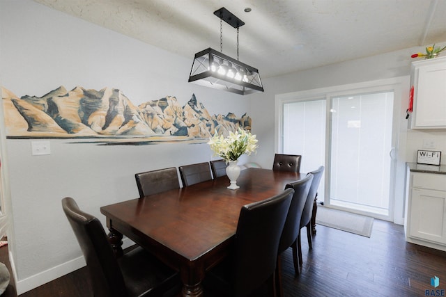 dining space with dark wood-type flooring and baseboards