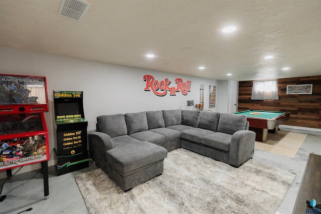 living room with visible vents, wood walls, concrete flooring, recessed lighting, and billiards