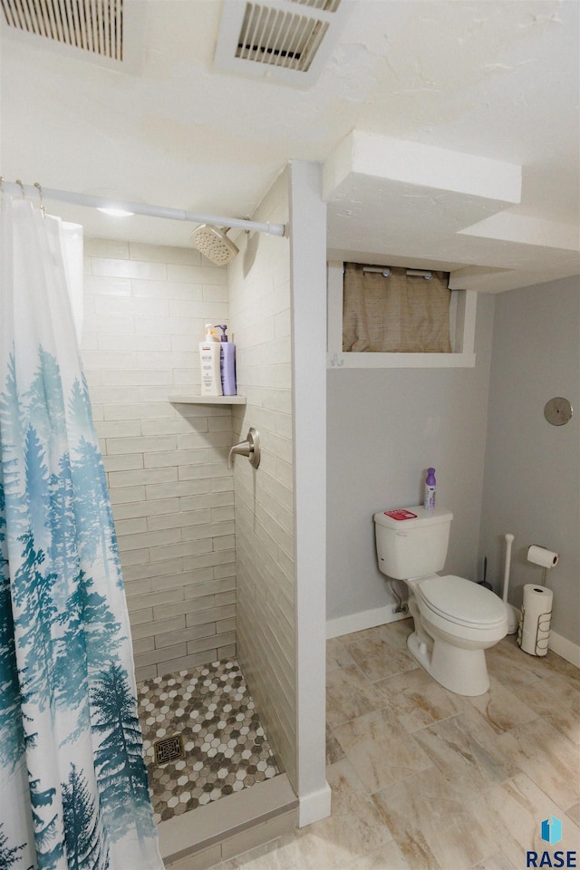 full bathroom featuring visible vents, tiled shower, toilet, and baseboards